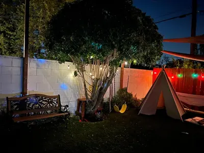 a tent and a tree in a yard at night at Sweet Tuscan Dreams-Private Entrance & Bathroom with Patio in Encino