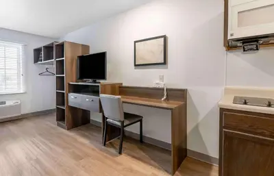 a room with a desk with a computer and a television at Extended Stay America Suites - Norco in Norco