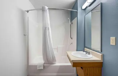 a bathroom with a shower curtain and a sink at Extended Stay America Suites - Redlands in Redlands