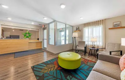 a living room with a couch and a green stool at Extended Stay America Suites - Redlands in Redlands