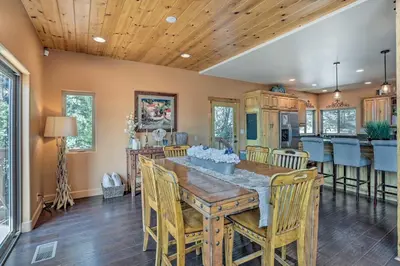 a kitchen and dining room with a wooden table and chairs at The Zen Playhouse with Lake Arrowhead Access! in Lake Arrowhead