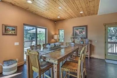 a dining room with a wooden table and chairs at The Zen Playhouse with Lake Arrowhead Access! in Lake Arrowhead