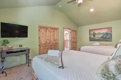a bedroom with two beds and a flat screen tv at The Zen Playhouse with Lake Arrowhead Access! in Lake Arrowhead