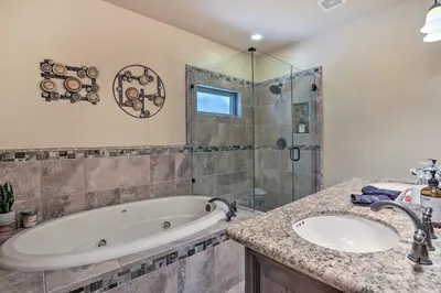 a bathroom with a tub and a shower and a sink at The Zen Playhouse with Lake Arrowhead Access! in Lake Arrowhead