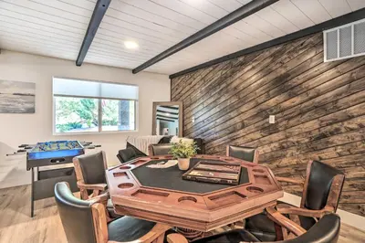 a dining room with a table and chairs at Luxe Timberland Villa with Lake Arrowhead Access! in Lake Arrowhead
