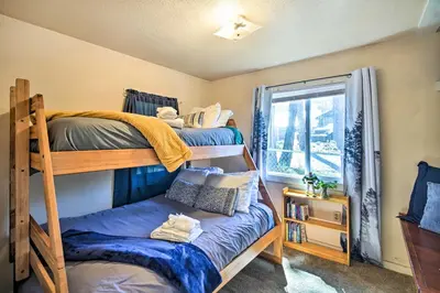 a bedroom with two bunk beds and a window at Grizzly Pine Cottage - Walk to Ski Beach Park! in Big Bear Lake
