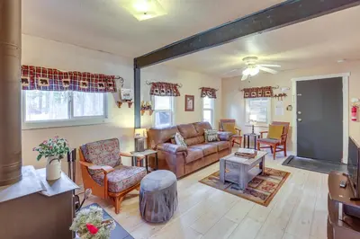 a living room with a couch and a table at Grizzly Pine Cottage - Walk to Ski Beach Park! in Big Bear Lake