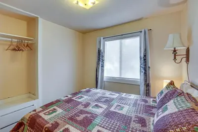 a bedroom with a bed and a window at Grizzly Pine Cottage - Walk to Ski Beach Park! in Big Bear Lake