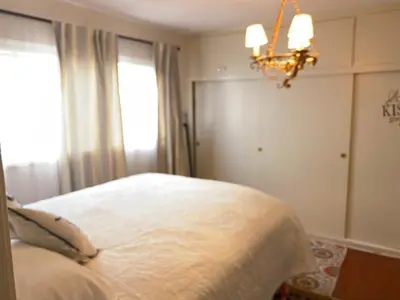 a bedroom with a bed with a chandelier and a window at Stay in Beverly Hills - Private Bedroom & Bath for female only - near Beverly Center, Cedars Sinai Hospital, The Grove in Los Angeles