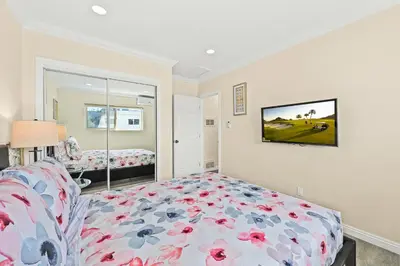 a bedroom with a bed with flowers on it at Sunny & Cheerful Near I-10 Queen Beds w Parking! in Alhambra