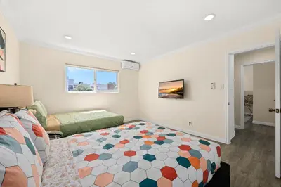 a bedroom with a bed and a living room at Sunny & Cheerful Near I-10 Queen Beds w Parking! in Alhambra
