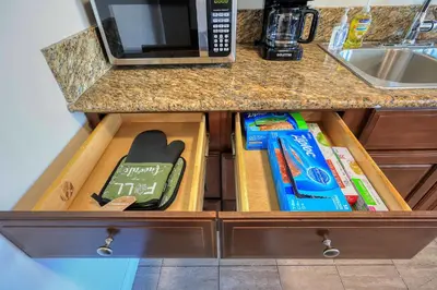 a drawer in a kitchen with books in it at Sunny & Cheerful Near I-10 Queen Beds w Parking! in Alhambra