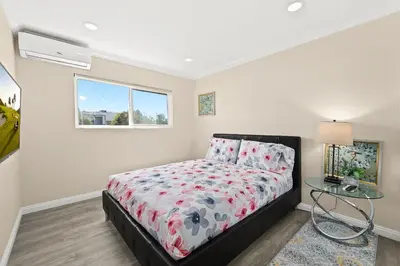 a bedroom with a bed and a glass table at Sunny & Cheerful Near I-10 Queen Beds w Parking! in Alhambra
