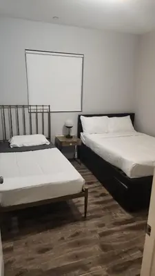 two beds sitting next to each other in a room at Stylish Modern Lake Balboa Retreat 3 Bedroom House in Van Nuys