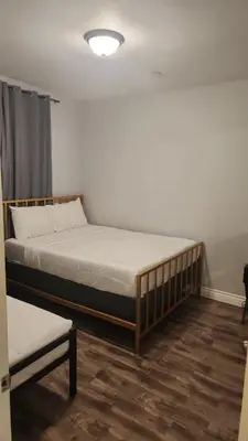a bedroom with a bed and a bench in it at Stylish Modern Lake Balboa Retreat 3 Bedroom House in Van Nuys