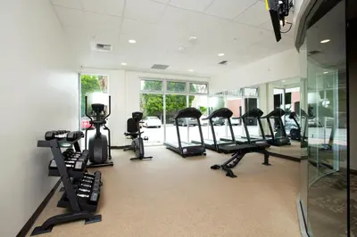 a gym with several treadmills and elliptical machines at Redac Gateway Hotel Torrance in Torrance