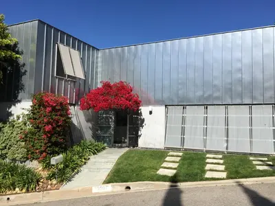 a building with red flowers on the side of it at Silver Box Beverly Hills in Los Angeles