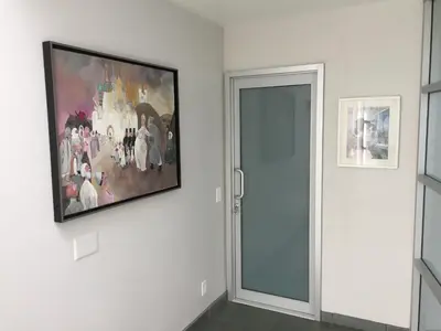 a painting hanging on a wall next to a door at Silver Box Beverly Hills in Los Angeles
