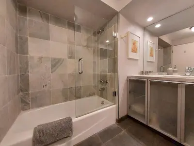 a bathroom with a shower and a tub and a sink at Silver Box Beverly Hills in Los Angeles