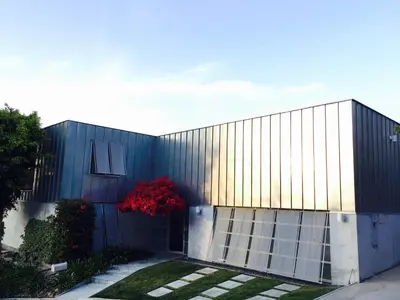 a blue building with a red tree in front of it at Silver Box Beverly Hills in Los Angeles
