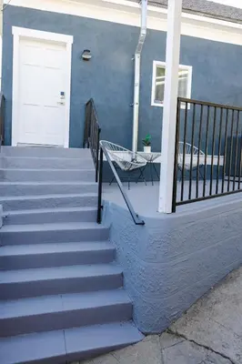 a blue building with stairs and a white door at Mid Century Modern - Walk to Dodger Stadium, DTLA in Los Angeles