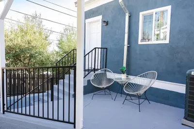 a patio with two chairs and a table on a house at Mid Century Modern - Walk to Dodger Stadium, DTLA in Los Angeles