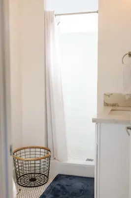 a bathroom with a tub and a window with a rug at Mid Century Modern - Walk to Dodger Stadium, DTLA in Los Angeles