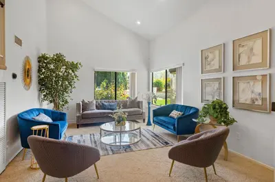 a living room with blue chairs and a table at Peaceful Private Retreat In The Heart Of Town in Redlands