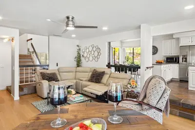 a living room with a couch and a table with wine glasses at Peaceful Private Retreat In The Heart Of Town in Redlands