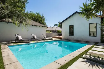 a swimming pool in front of a house at Modern Bungalow with a Pool in Larchmont Village in Los Angeles