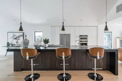 a kitchen with a large island with a counter top at Modern Bungalow with a Pool in Larchmont Village in Los Angeles