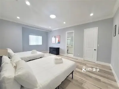 a living room with two beds and a couch at Huge Family Home Near Disneyland & SoCal Beaches in Midway City