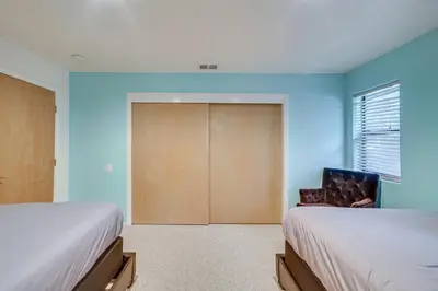 a bedroom with two beds and a sliding door at Pine Mountain Club Home with Beautiful View! in Frazier Park