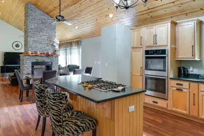a kitchen with a stove top island in a room at Pine Mountain Club Home with Beautiful View! in Frazier Park