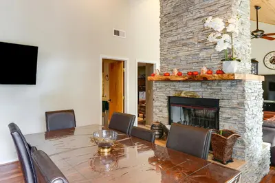 a dining room with a table and a fireplace at Pine Mountain Club Home with Beautiful View! in Frazier Park