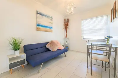 a living room with a blue couch and a table at Inviting Home in Historic Leimert Park in Los Angeles
