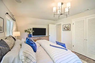 a bedroom with two beds and a flat screen tv at Chic Lake House with Furnished Deck and Hot Tub! in Lake Arrowhead