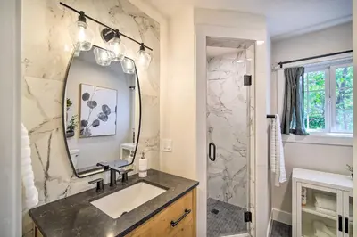 a bathroom with a sink and a mirror at Chic Lake House with Furnished Deck and Hot Tub! in Lake Arrowhead
