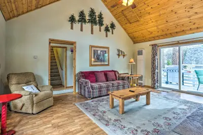 a living room with a couch and a table at Château Forêt in Big Bear with Hiking Trail Access in Big Bear City