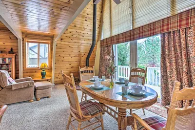 a dining room with a table and chairs in a cabin at Château Forêt in Big Bear with Hiking Trail Access in Big Bear City