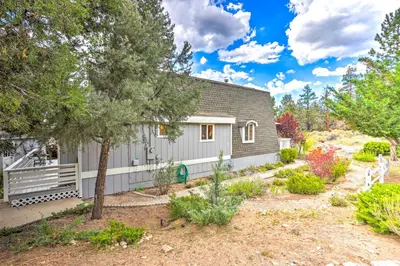 a house with a garden in front of it at Château Forêt in Big Bear with Hiking Trail Access in Big Bear City