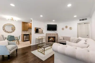 a living room with two white couches and a fireplace at Luxury 2-Bedroom Condo in Studio City in Los Angeles