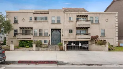 a large house with a driveway in front of it at Luxury 2-Bedroom Condo in Studio City in Los Angeles