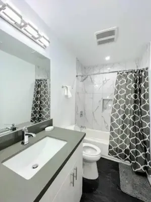 a bathroom with a sink and a toilet and a shower at 4BR Townhouse in KoreaTown in Los Angeles
