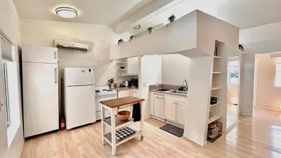 a kitchen with a white refrigerator and a wooden floor at Echo Park Hills - Walk to Dodger Stadium - Near DTLA SoFi in Los Angeles