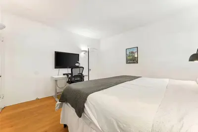 a white bedroom with a bed and a tv at Echo Park Hills - Walk to Dodger Stadium - Near DTLA SoFi in Los Angeles