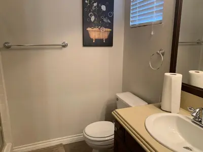 a bathroom with a white toilet and a sink at High End Triplex with Pool in Riverside