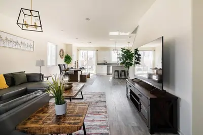 a living room with a couch and a table at Spacious Modern Home in Sierra Lakes Fontana in Fontana