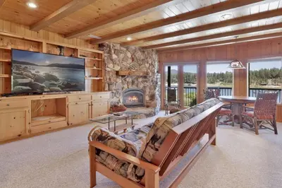 a living room with a couch and a fireplace at Cove Lakefront Chalet #2098 by Big Bear Vacations in Big Bear Lake