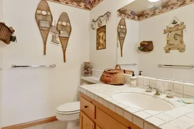 a bathroom with a sink and a toilet at Cove Lakefront Chalet #2098 by Big Bear Vacations in Big Bear Lake
